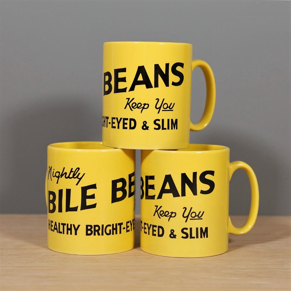 Three yellow porcelain mugs with 'Bile Beans' and health-related phrases printed in black.